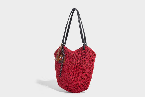 Woven crochet open-top shoulder tote bag with slim brown leather-look straps and braided charm accent, detail view 8