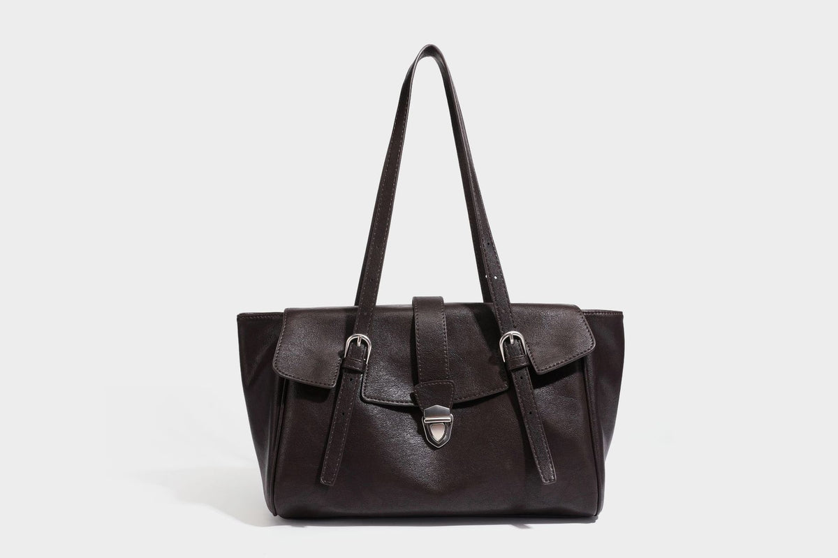 Large structured vintage-style tote bag with flap-front turn-lock closure, twin buckle straps, and double shoulder handles