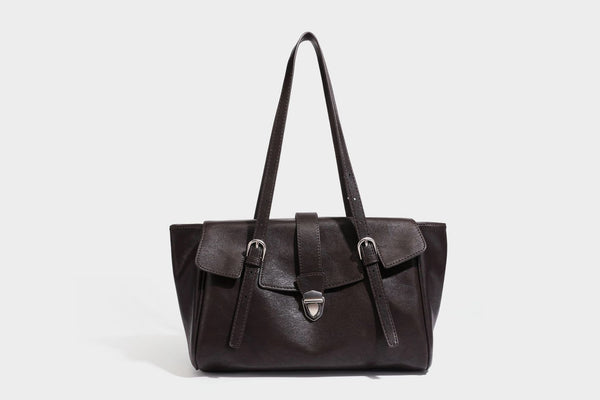 Large structured vintage-style tote bag with flap-front turn-lock closure, twin buckle straps, and double shoulder handles
