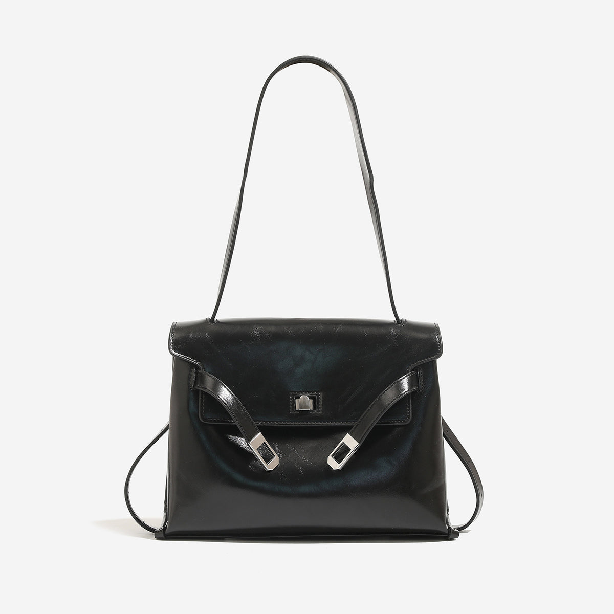Structured trapezoidal flap satchel bag with silver-tone turn-lock clasp, decorative front strap tabs, gusseted sides, and