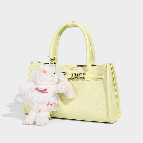 Structured trapezoid tote bag in pebbled leather-look finish with double top handles, silver-tone bar hardware, and, front