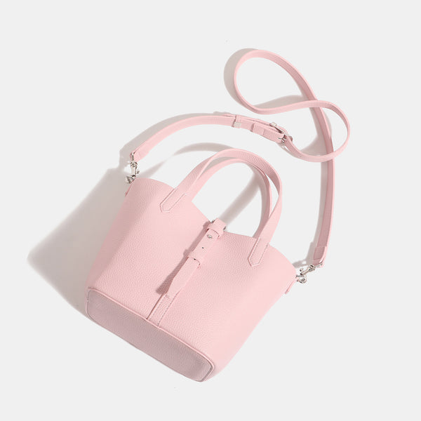 Small structured pebbled leather-look bucket tote bag with dual top handles and silver-tone hardware, detail view 4