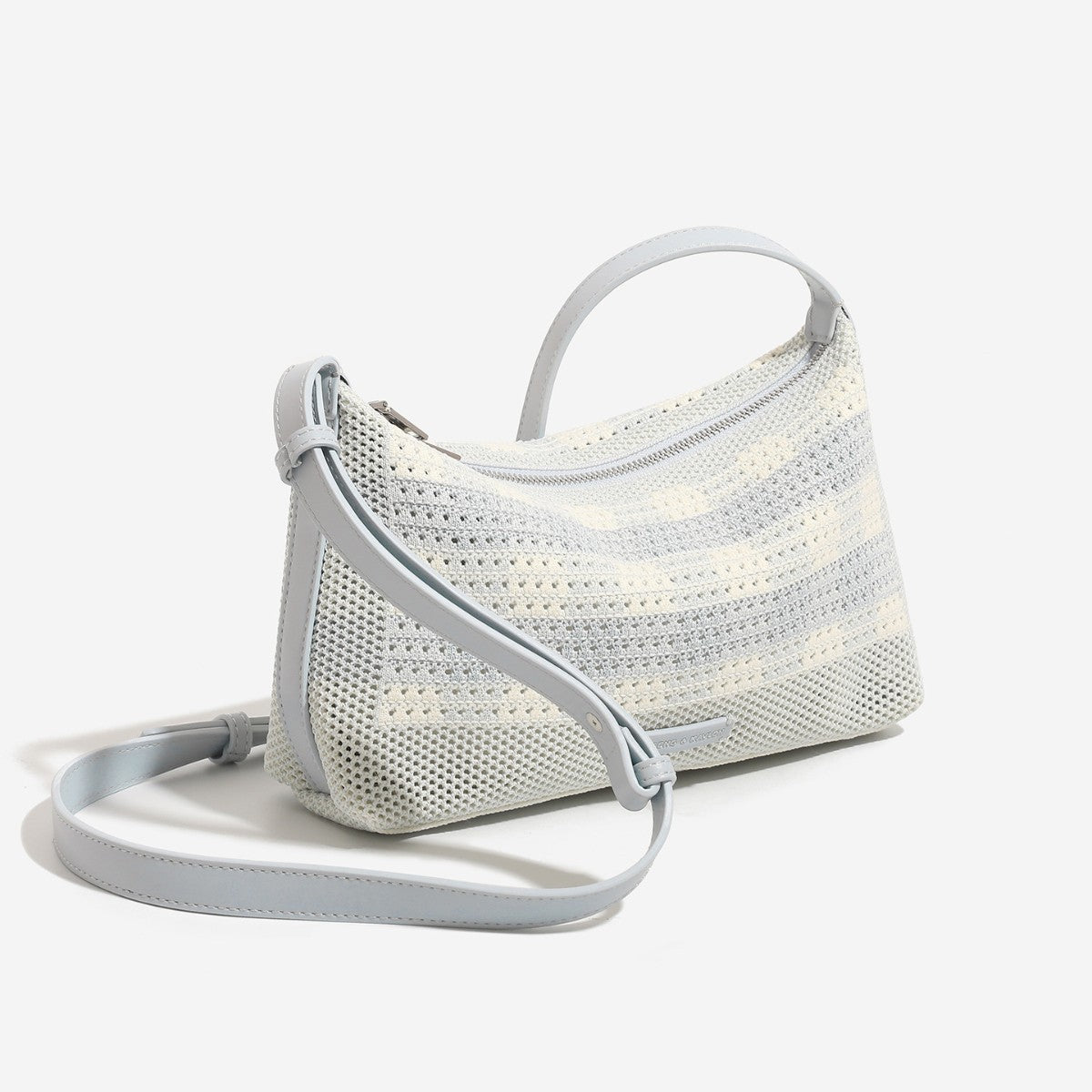 Woven crescent hobo shoulder bag with adjustable leather-look strap and top zip closure, detail view 2