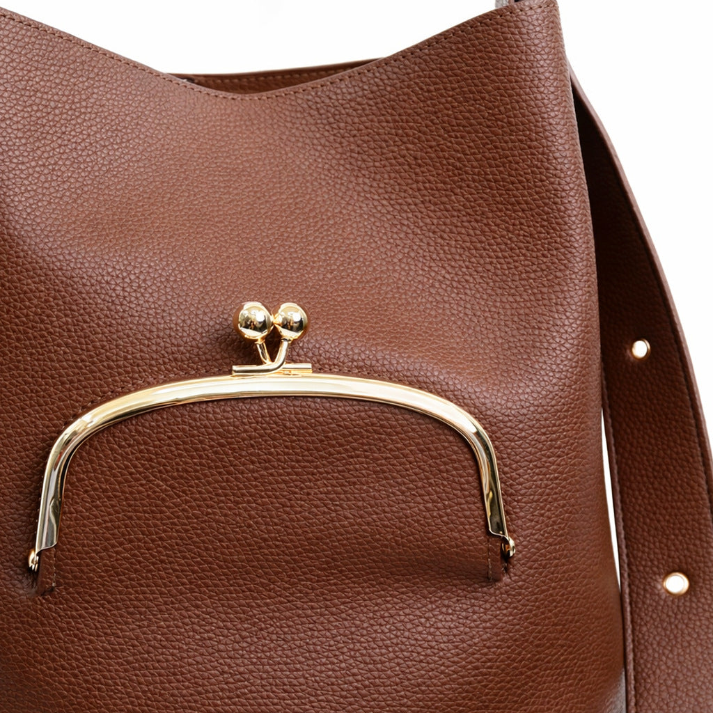 Pebbled textured bucket bag with gold-tone kiss-lock front pocket and adjustable single shoulder strap, detail view 19