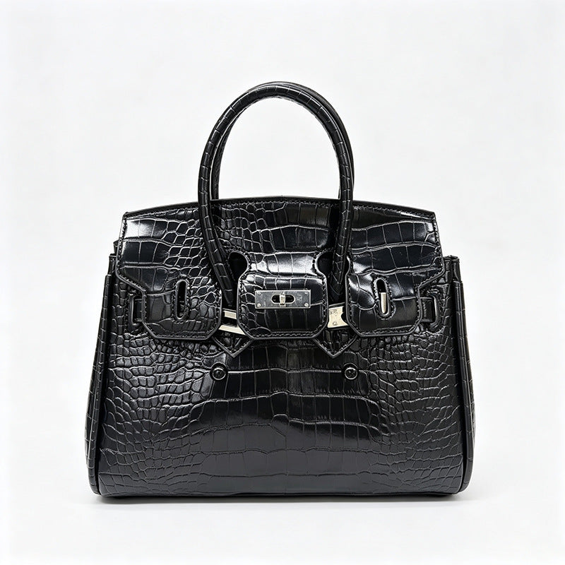 Croc-embossed structured trapezoid satchel with silver turn-lock hardware, rounded top handles, and detachable shoulder
