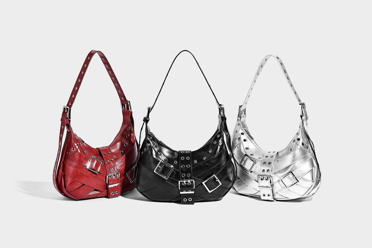 Glossy crescent hobo bag with silver-tone grommets, square buckle straps, and top zipper closure, detail view 9