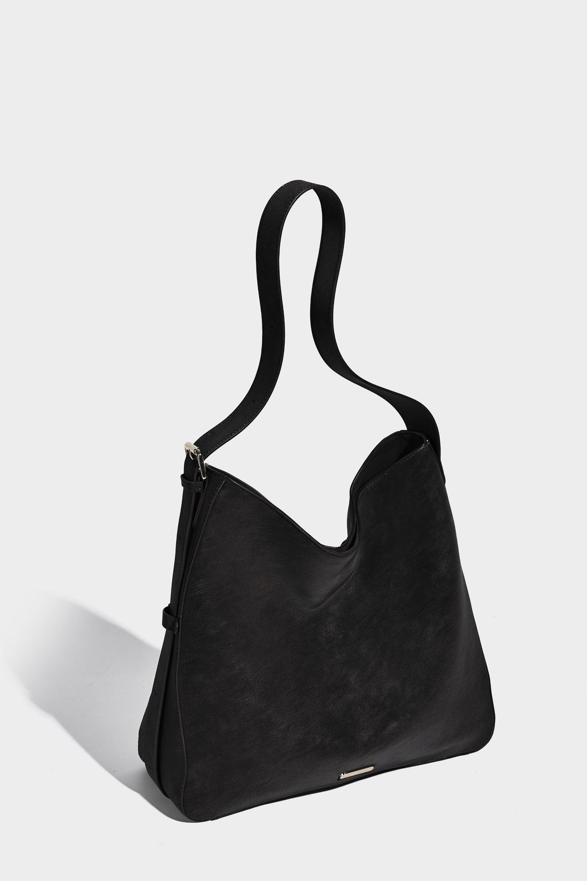 Large slouchy hobo shoulder bag in matte leather-look finish with adjustable strap and gold-tone bar hardware, detail view 24