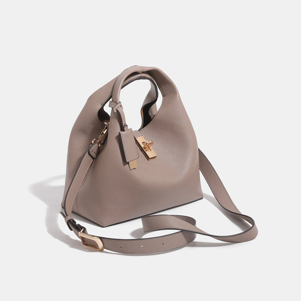 Structured pebbled leather-look bucket tote with gold-tone turn-lock hardware and looped top handle, detail view 3