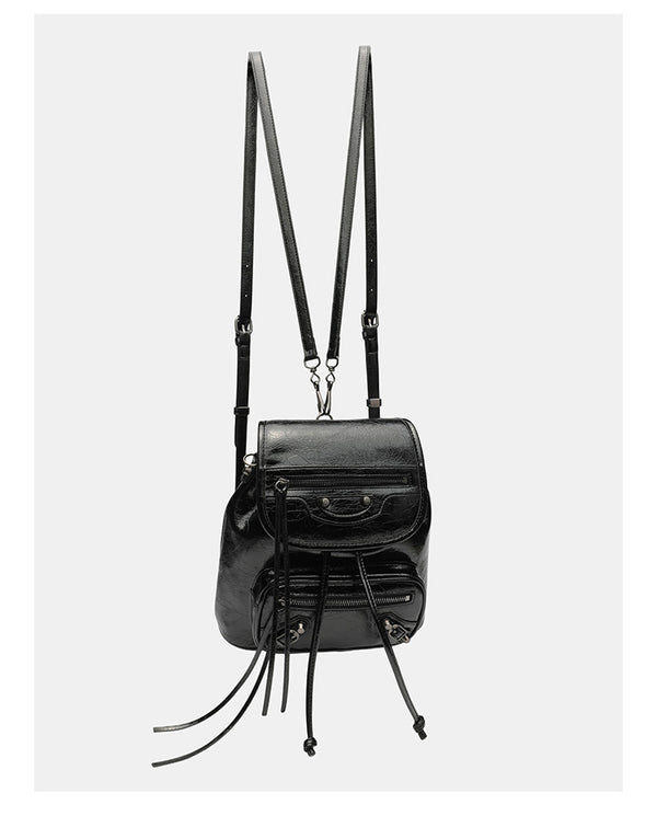 Small structured glossy leather-look convertible backpack handbag in black with flap closure, front zip pockets, metal stud