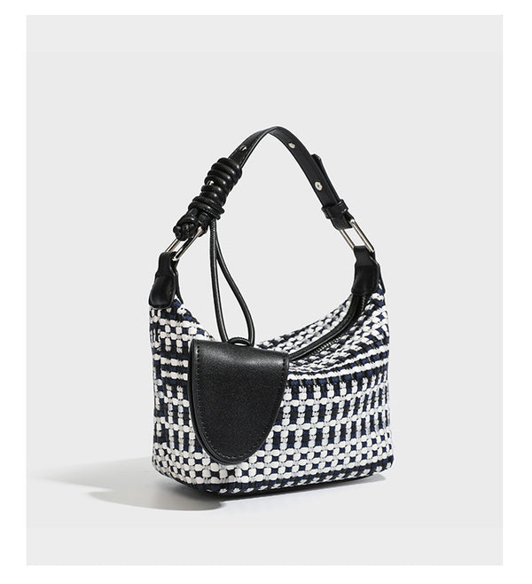 Small crescent shoulder bag in black-and-white woven textile with smooth black leather-look trim, zip-top closure, knotted