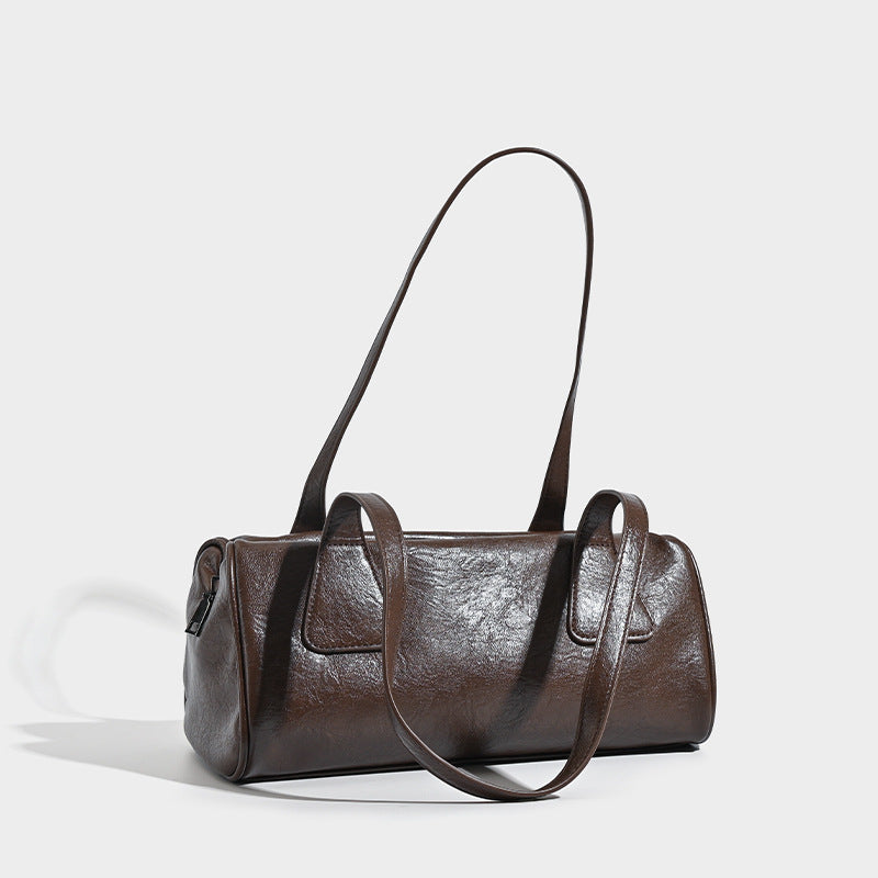 Glossy leather-look barrel shoulder bag with zip closure and top handles, detail view 3