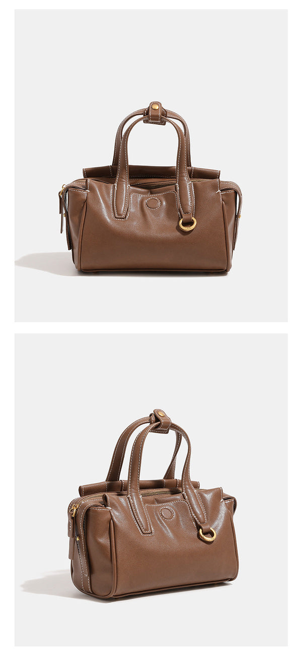 Compact structured satchel bag with dual top handles, gold-tone O-ring hardware, contrast topstitching, and detachable