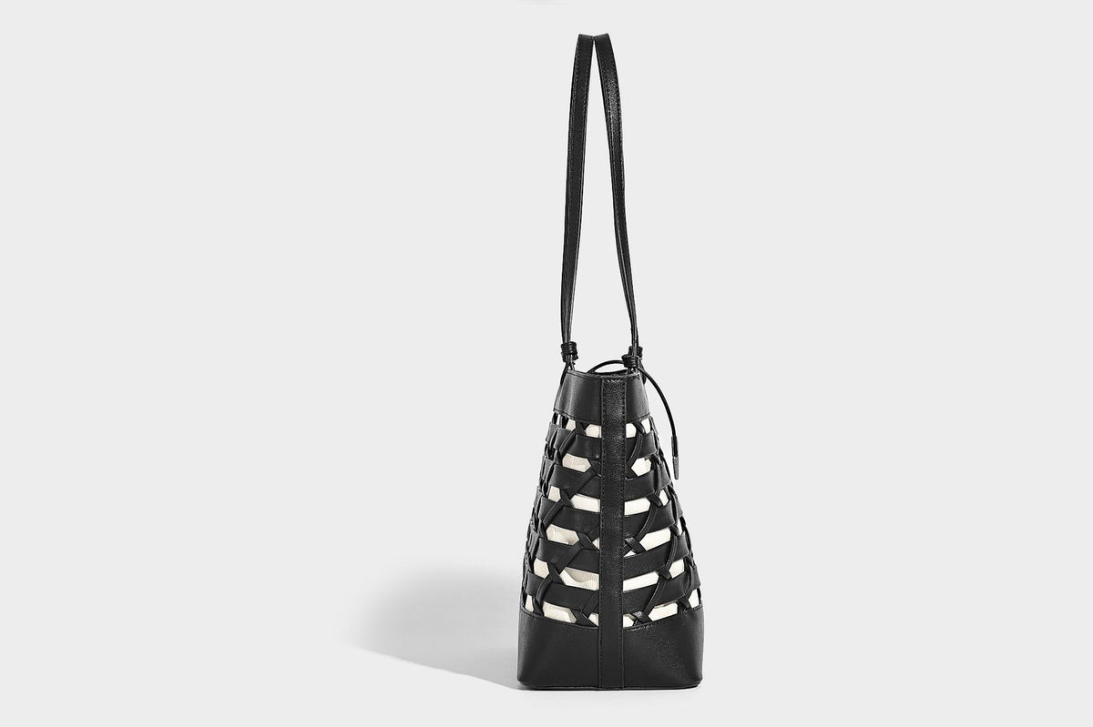 Structured woven lattice cutout tote bag with smooth leather-look trim, dual shoulder straps, and silver-tone hardware