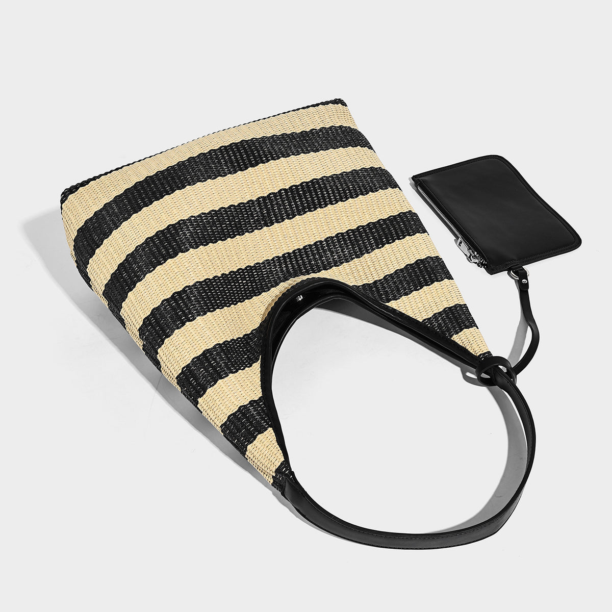 Black and beige striped woven shoulder tote bag with leather-look trim and detachable black zip pouch, detail view 4