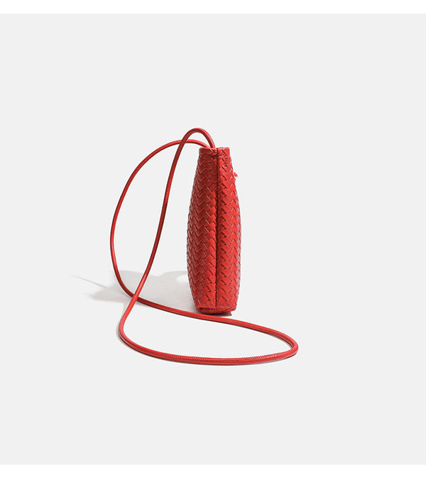 Compact woven leather-look bucket crossbody pouch with toggle closure and long fixed strap, detail view 9