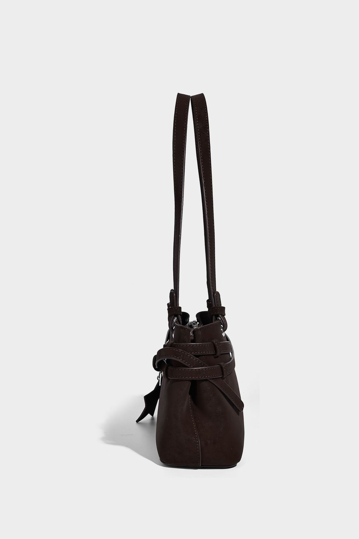 Structured trapezoid shoulder tote in dark brown matte suede-look finish with dual straps, wraparound belt bands