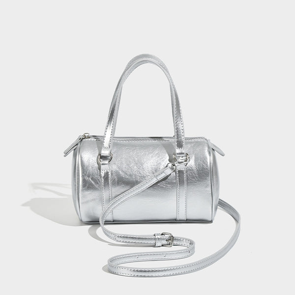 Mini silver barrel bag with crinkled leather-look finish, top handles, and silver-tone hardware, detail view 6