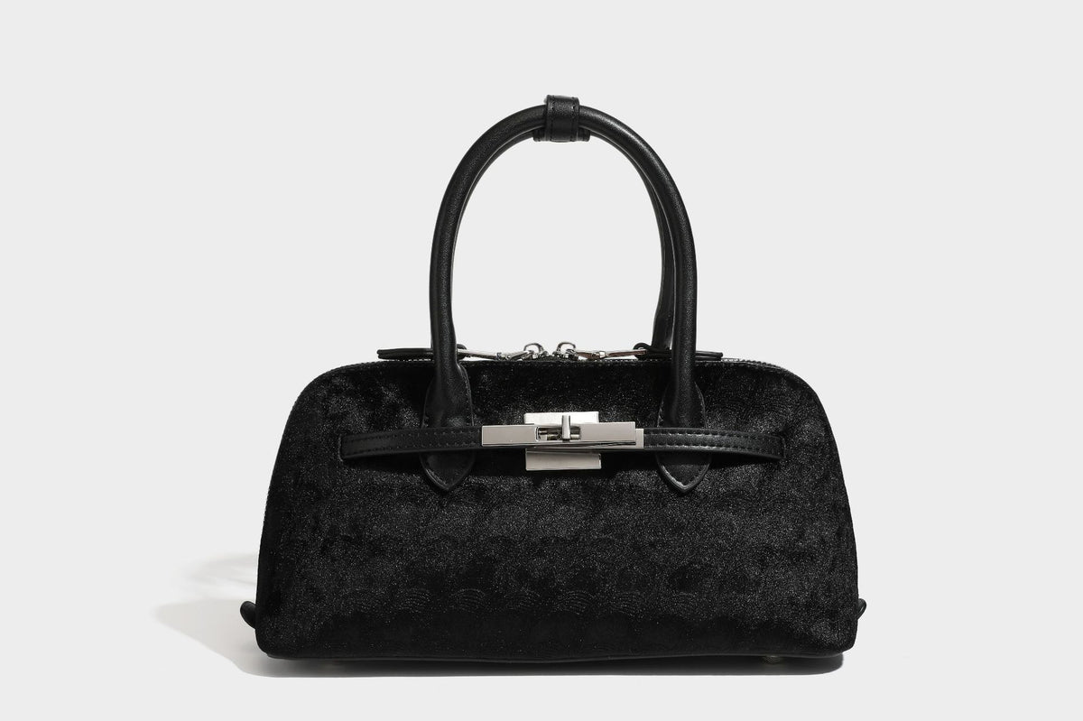 Small structured satchel bag in dark brown velvet-like textured finish with leather-look trim, silver-tone turn-lock bar