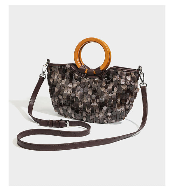 Small sequin half-moon handbag with circular wood-look ring handles and detachable leather-look shoulder strap, detail view