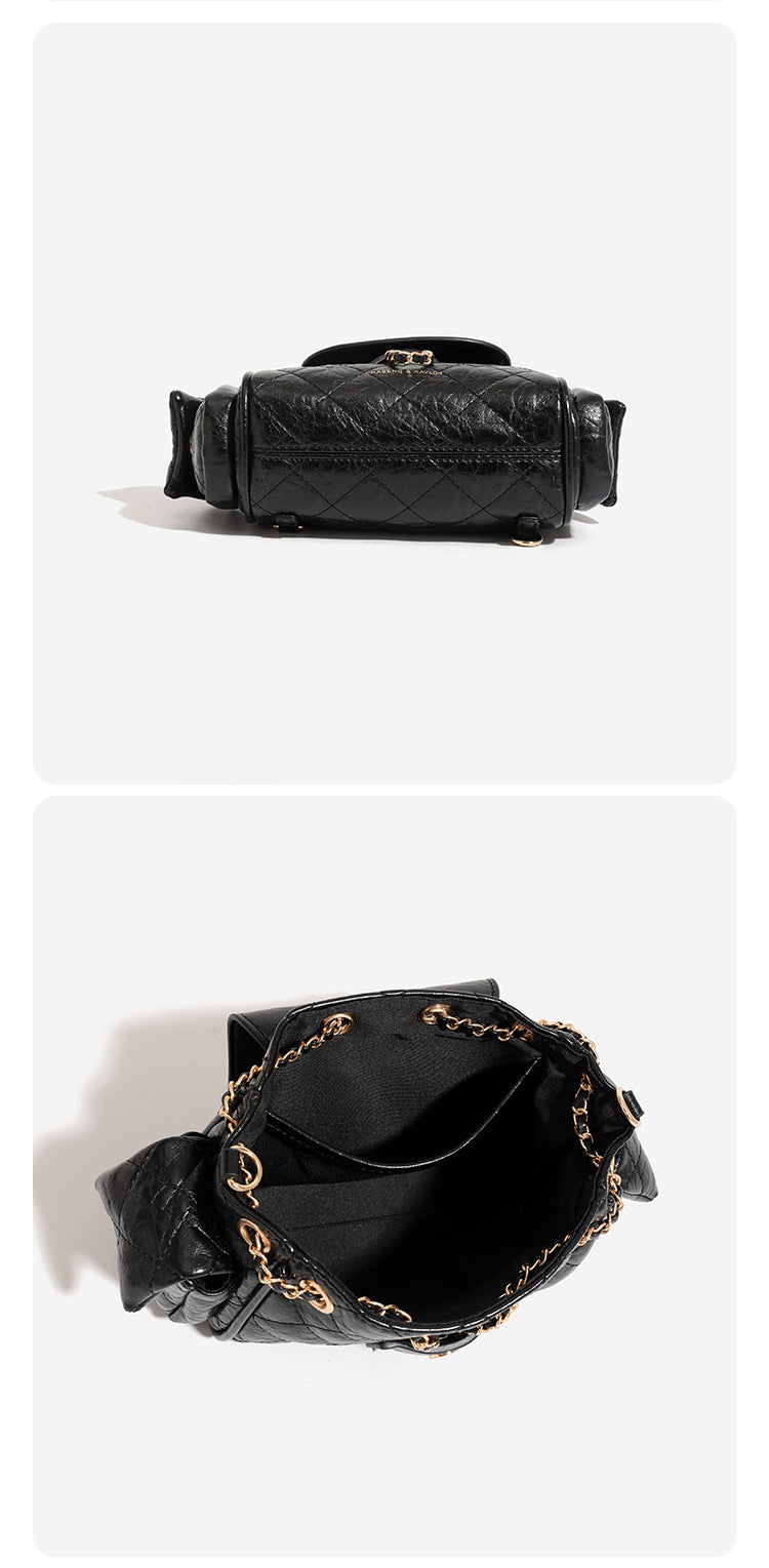 Compact quilted crinkle-finish flap bag with gold-tone chain strap and decorative chain closure detail, detail view 8