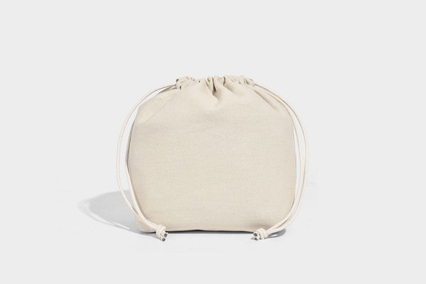 Structured pebbled leather-look tote bag in taupe with long shoulder strap, detachable zip pouch, and pink tulip flower