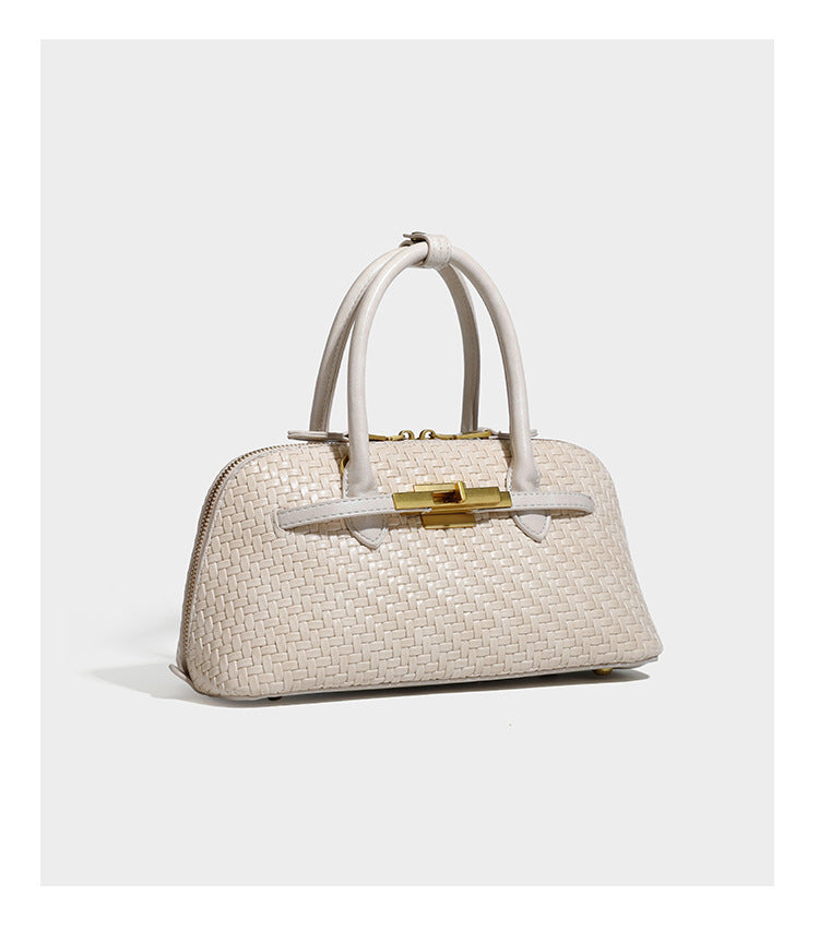 Structured woven-embossed leather-look satchel with dual rolled top handles, gold-tone turn-lock closure, and detachable