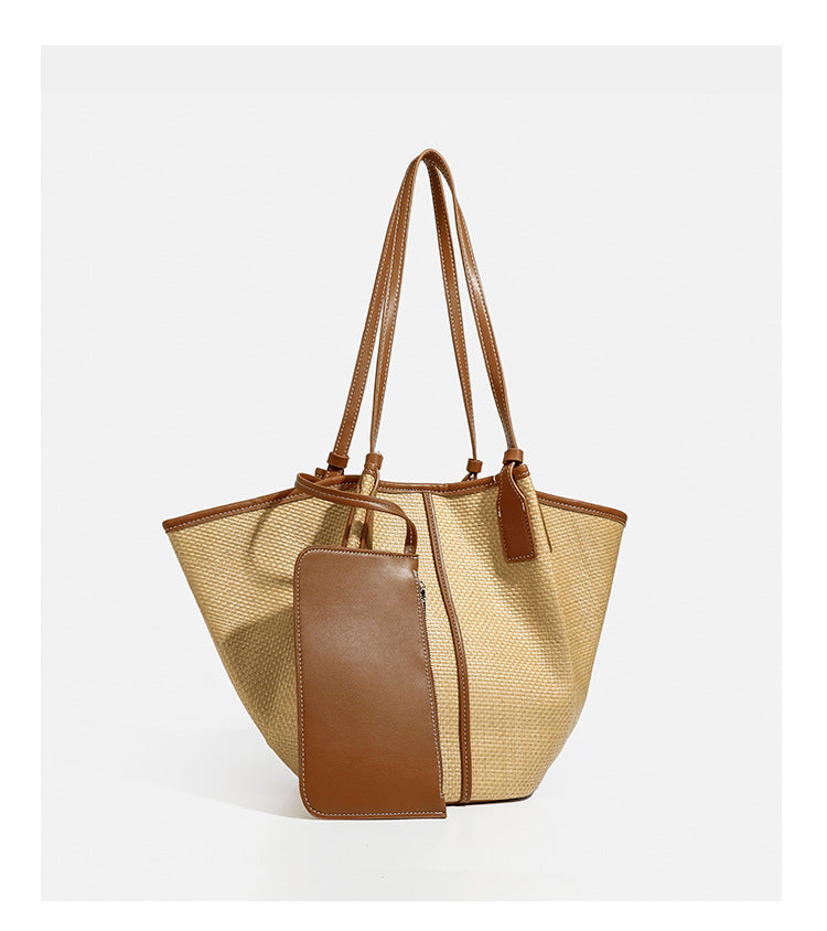 Tan woven tote bag with contrasting leather-look trim, long shoulder straps, and detachable rectangular zip pouch, detail