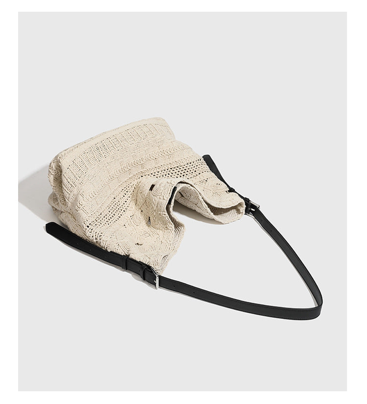 Cream woven rope-cord hobo bag with black adjustable leather-look strap and matching cream drawstring pouch, detail view 8