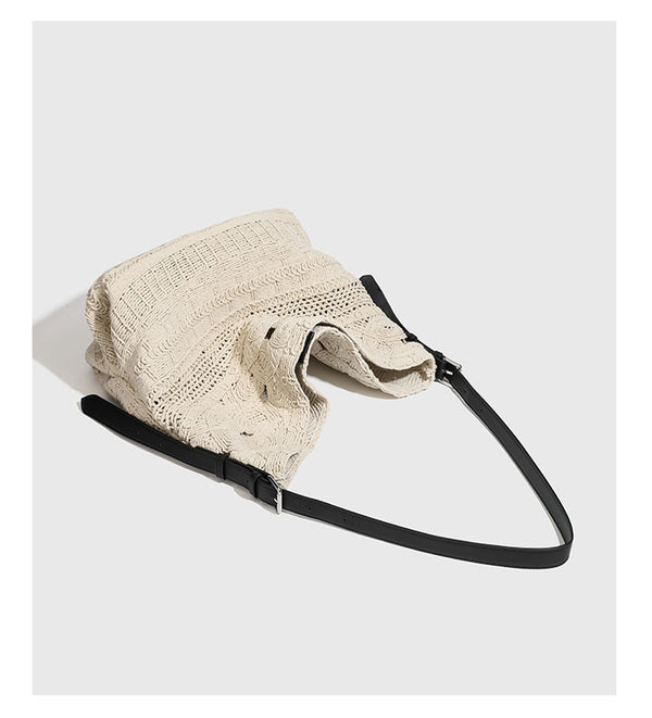 Cream woven rope-cord hobo bag with black adjustable leather-look strap and matching cream drawstring pouch, detail view 8
