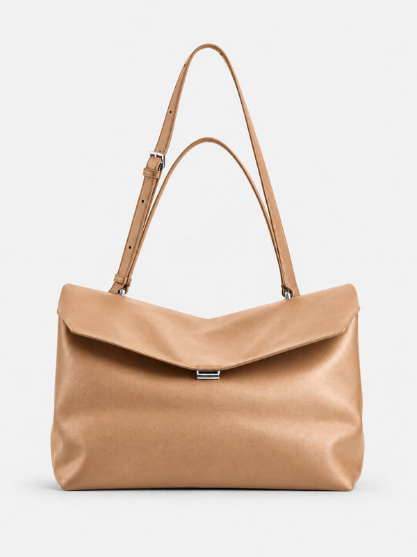 Large black slouchy leather-look shoulder bag with V-shaped envelope flap, silver-tone clasp, and adjustable strap, detail