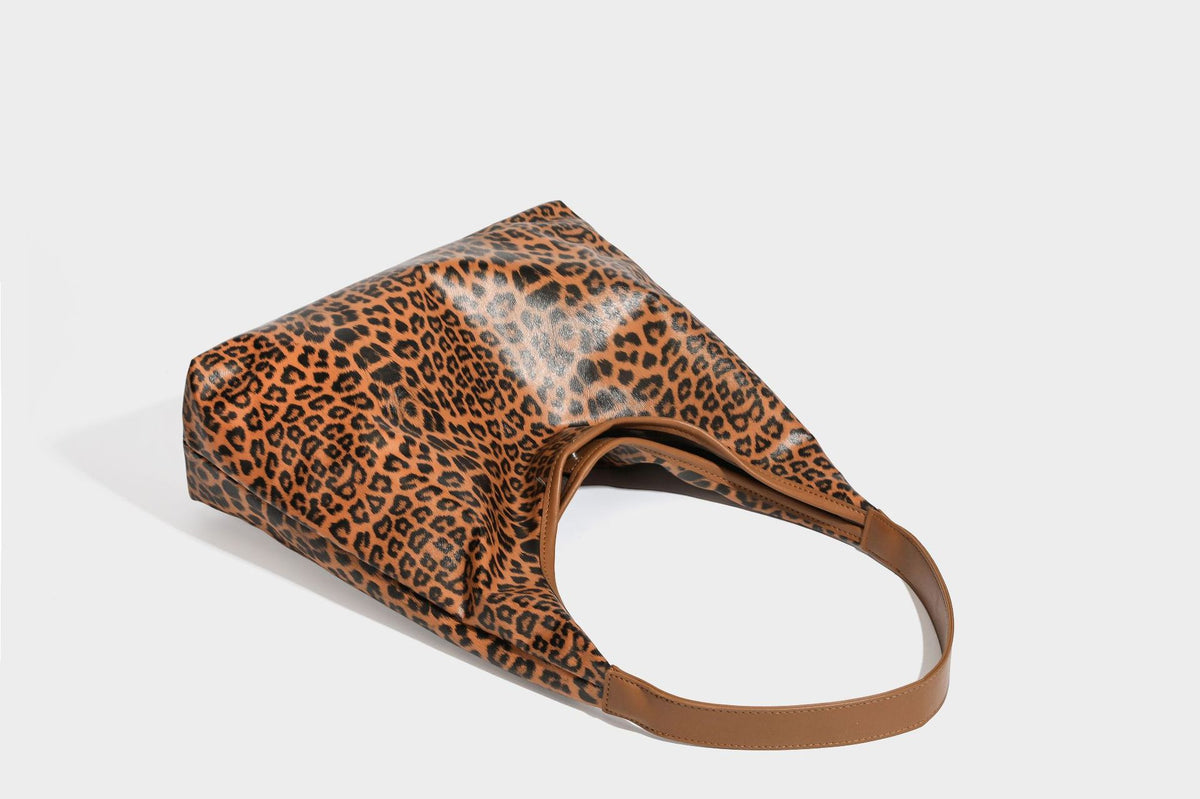 Glossy leopard-print slouchy shoulder bag with long strap and detachable tan zip pouch, detail view 31