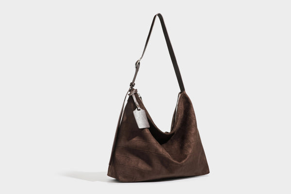 Slouchy hobo shoulder bag in matte croc-embossed leather-look finish with top zip closure and long adjustable strap, detail