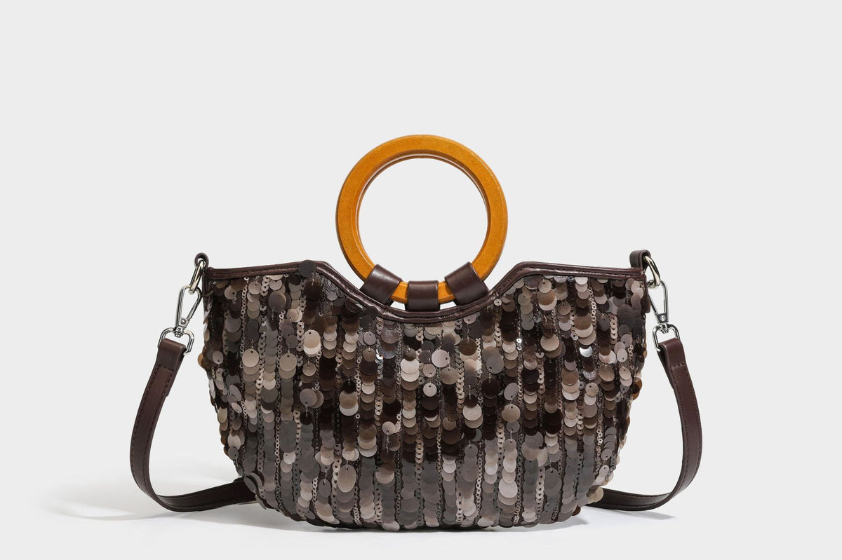 Small sequin half-moon handbag with circular wood-look ring handles and detachable leather-look shoulder strap, detail view