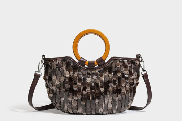Small sequin half-moon handbag with circular wood-look ring handles and detachable leather-look shoulder strap, detail view