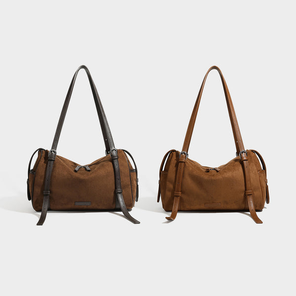 Large brown suede-finish barrel shoulder bag with dark leather-look trim, silver-tone zippers, dual top handles, and long