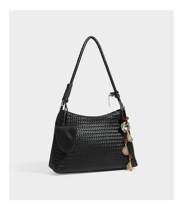 Woven-texture hobo shoulder bag in brown with braided top handle, adjustable crossbody strap, front flap pocket, and, detail
