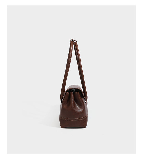 Structured rectangular satchel bag with dual rounded top handles and central metal turn-lock flap closure, detail view 9