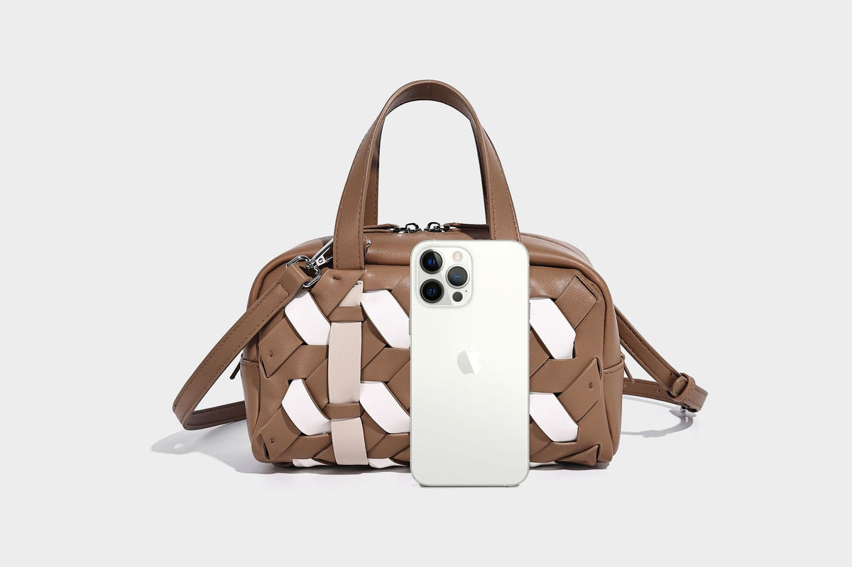 Small structured satchel bag with two-tone woven front panel, dual top handles, and detachable crossbody strap in tan brown