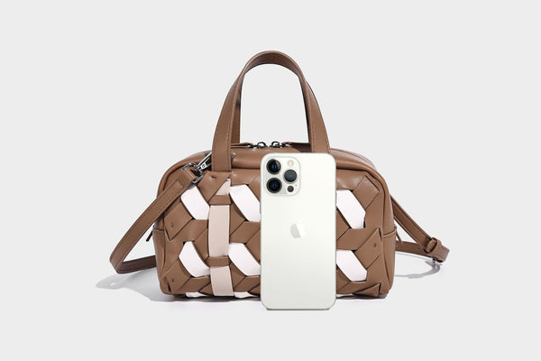 Small structured satchel bag with two-tone woven front panel, dual top handles, and detachable crossbody strap in tan brown