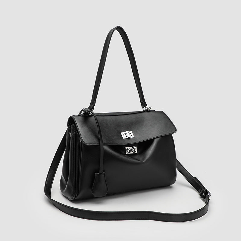 Structured black leather-look flap satchel bag with silver turn-lock hardware and top handle, detail view 3