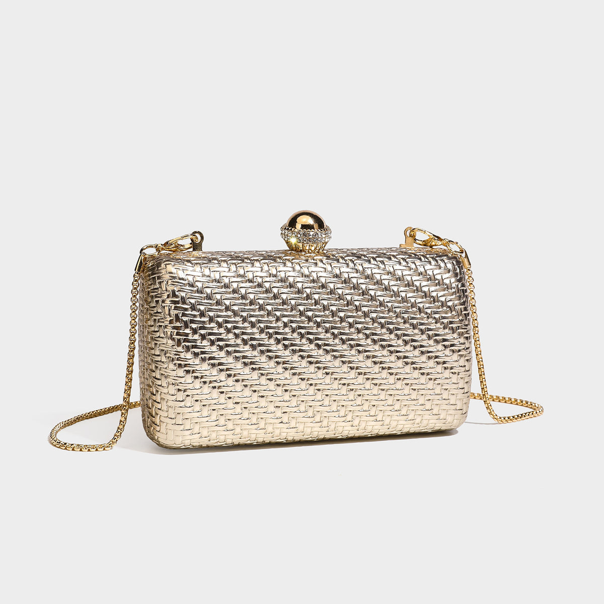 Small structured metallic woven-texture box clutch bag with jeweled kiss-lock dome clasp and slim gold chain strap, detail