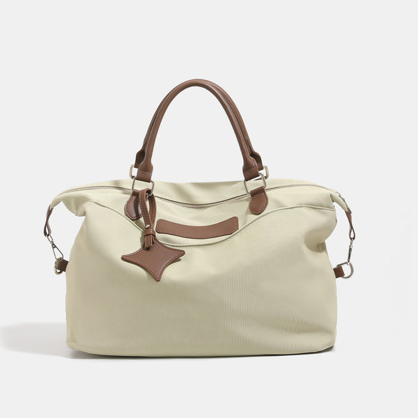 Large slouchy nylon tote bag with brown leather-look handles, double-pull zip closure, and star charm detail, detail view 7