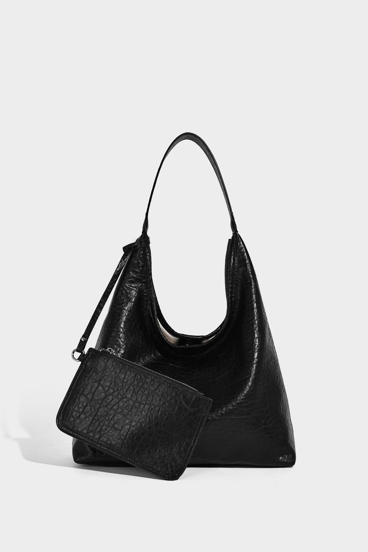 Slouchy hobo shoulder bag in pale yellow glossy pebbled leather-look finish with single shoulder strap and detachable front