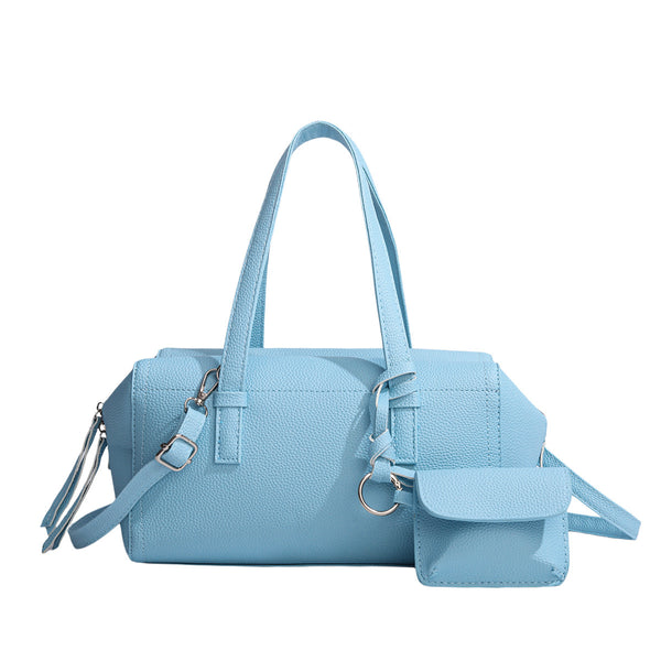 Light blue pebbled matte Boston tote bag with top handles, detachable shoulder strap, metal ring hardware, and matching mini