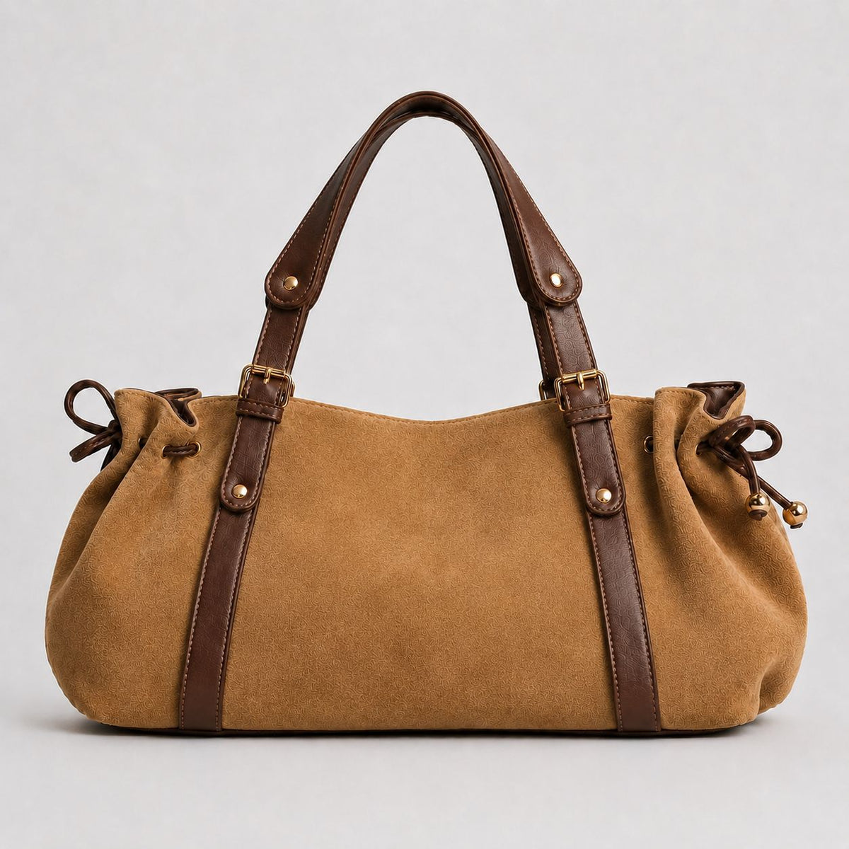Soft suede-texture shoulder bag in brown with drawstring sides, leather-look vertical straps, gold-tone buckle hardware, and