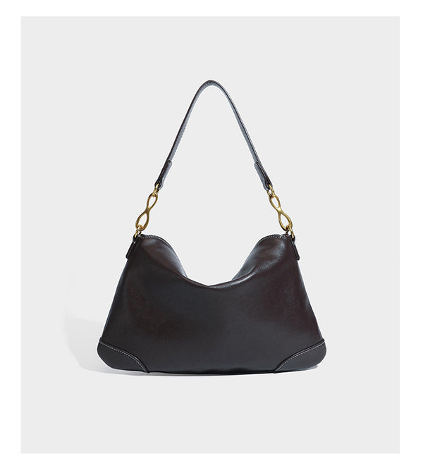 Slouchy denim shoulder bag with dark leather-look trim, gold-tone chain-link hardware, and top zipper closure, detail view 10