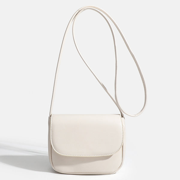 Compact rounded rectangular flap crossbody bag with glossy leather-look finish and long shoulder strap, detail view 9