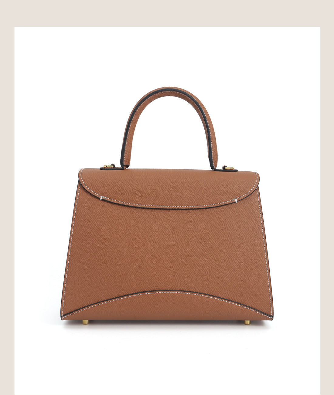 Structured trapezoid top-handle satchel in golden brown cross-grain textured finish with gold M-shaped clasp hardware and