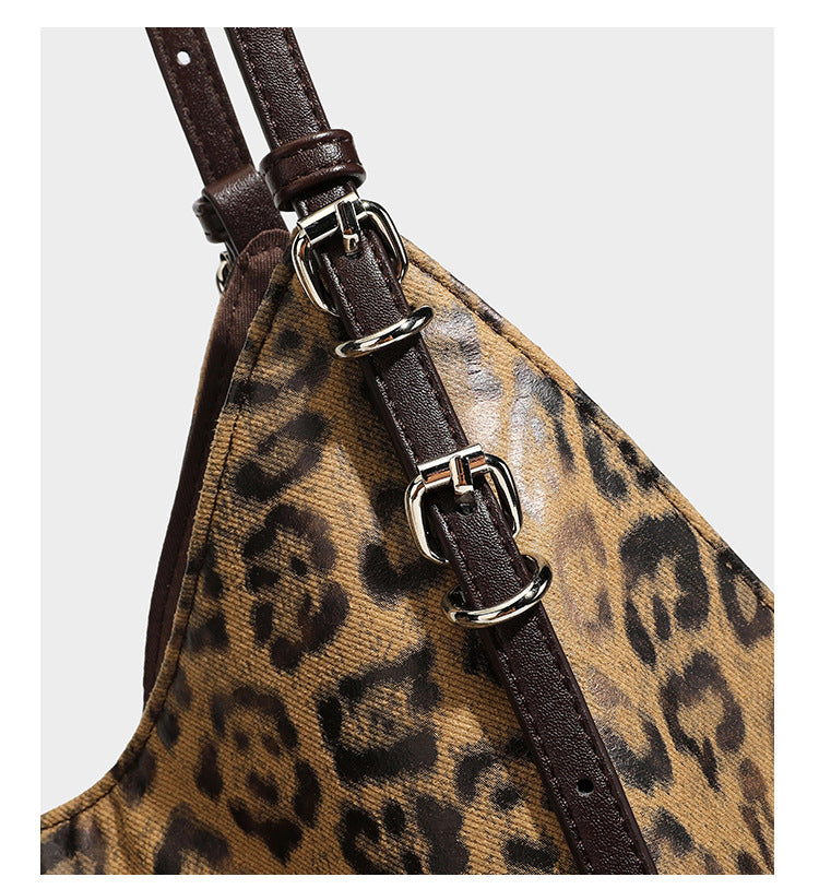 Slouchy leopard-print shoulder tote bag in tan and brown with long double straps, side tie straps, and dangling charm, detail