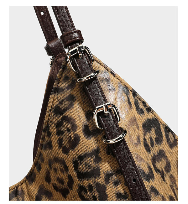 Slouchy leopard-print shoulder tote bag in tan and brown with long double straps, side tie straps, and dangling charm, detail